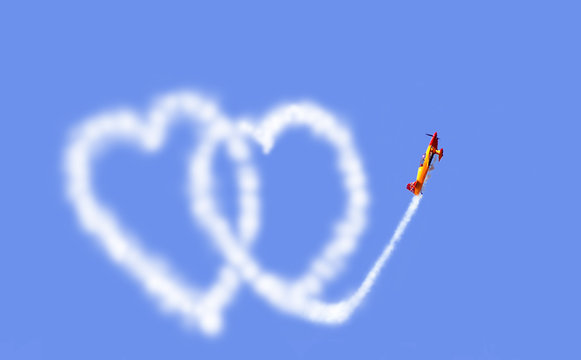     an aeroplane drawing hearts in the sky