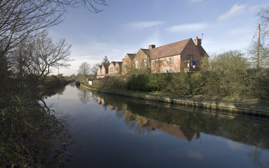Naklejka na ściany i meble Houses next to canal or river.
