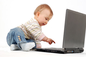 baby having fun with laptop