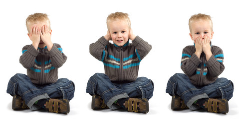 Young boy playing don't see, don't hear, don't speak.