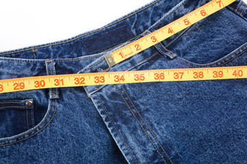 a blue jean and ruler, concept of weight loss