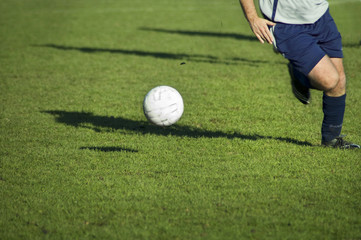soccer player in action. running after bal on soccer field.