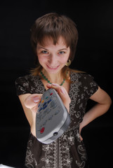 Young woman with tv remote control 