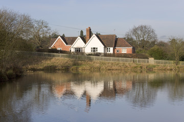 Fototapeta na wymiar Houses next to lake or river or canal.