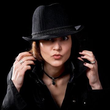 Young woman in hat isolated on the black background
