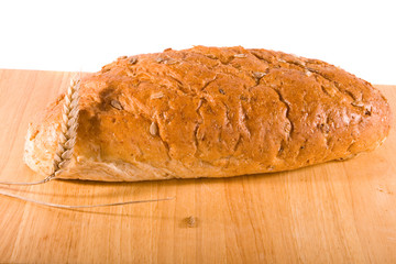 Loaf of Bread on Board with Ear of Wheat