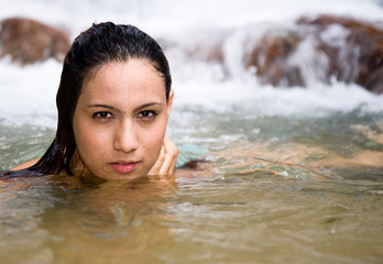 woman swimming in the waterfall
