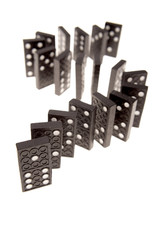 Dominoes standing in a row over white background