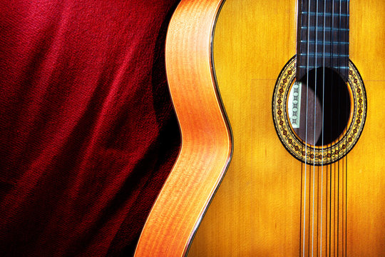 Old acoustic guitar on red background. With clipping path