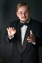 Choir conductor wearing a black tuxedo