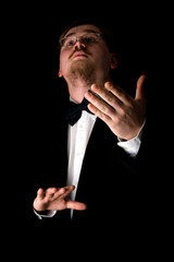 Choir conductor wearing a black tuxedo - 6248857