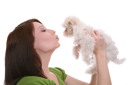 A pretty woman showing love (kissing) to her dog