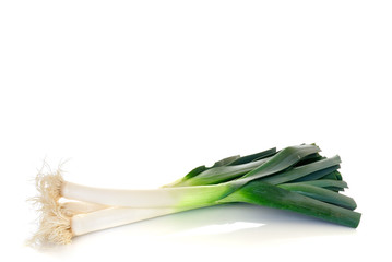 Fresh green leek on reflective surface, studio shot, 