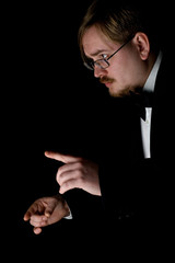 Choir conductor wearing a black tuxedo