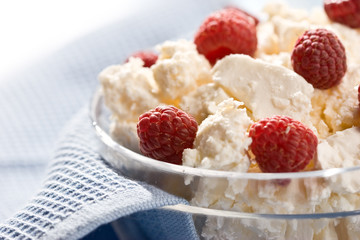 Glass bowl with soft cheese and raspberry