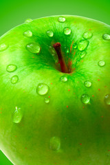 ripe apple on green background