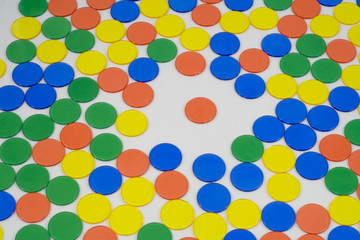 Colourfull Counters on a white background, mixed up colours