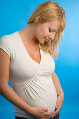 the young pregnant woman on blue background