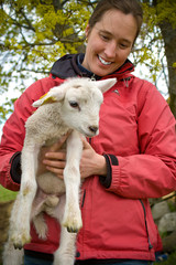 woman holding a lamb in her arms