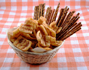 Basket to beer with chips and salty grain sticks