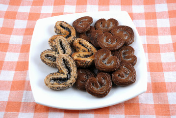 Sweet biscuit cookies in the form of heart on a white plate