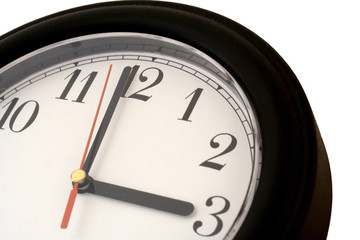 Black clock showing the time just before 3 o'clock