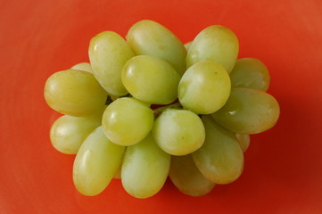 Green grapes on ceramic plate