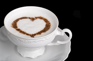 Coffee cappuccino cup with cinnamon heart shape