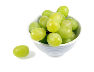 Green Grapes in a small white bowl isolated on white background.