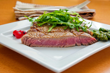 grilled beef steak with tomato slices and asparagus