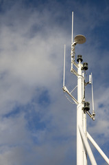 Mast against White Clouds