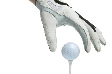 Close up of a gloved hand putting a golf ball on a tee