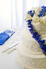 wedding cake decorated with blue delphiniums