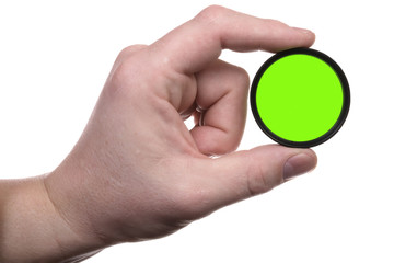 hand holds a green optical filter. Isolated with clipping path