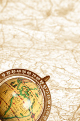 old globe on background of map