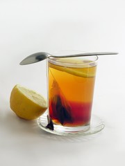 glass of tea and lemon fruit and slice
