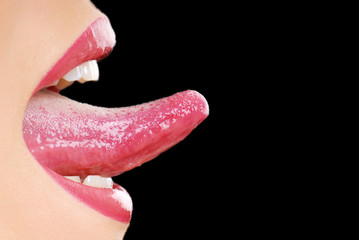 Long human tongue on the black background