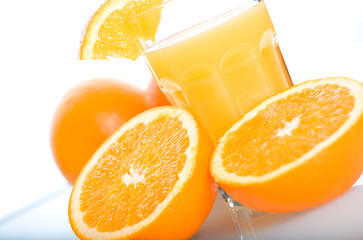 Oranges and a glass of orange juice