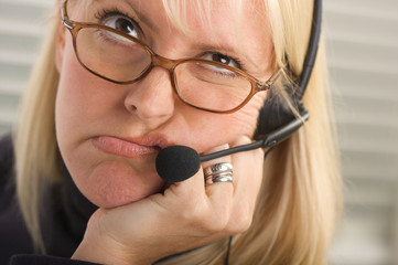 Unhappy Bored Telemarketer Businesswoman Wearing Phone Headset - obrazy, fototapety, plakaty