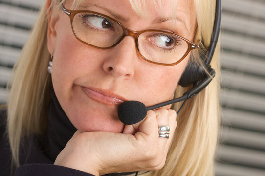 Bored Exasperated Businesswoman Wearing A Phone Headset