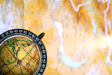 old globe on background of map