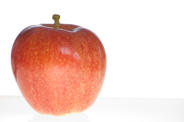 A Fuji apple sitting on a light table 