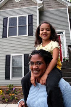 A Mother With Her Child In The Front Yard