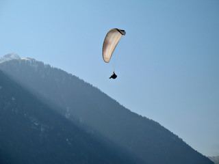 A paraglider il flying in the blue sky