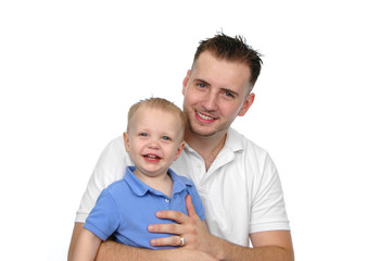 Father and son smiling agains a white background