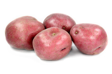 Tubers of red potatoes over white background.