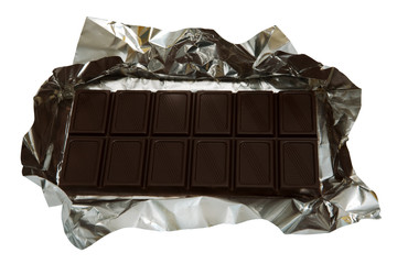 Dark chocolate in a foil on a white background