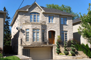 Large modern suburban house with porch over garage
