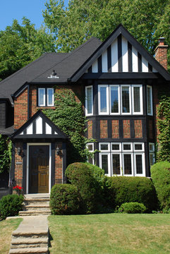 Small Tudor Style House With Black And White Trim