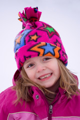 Little Girl playing outside in the snow